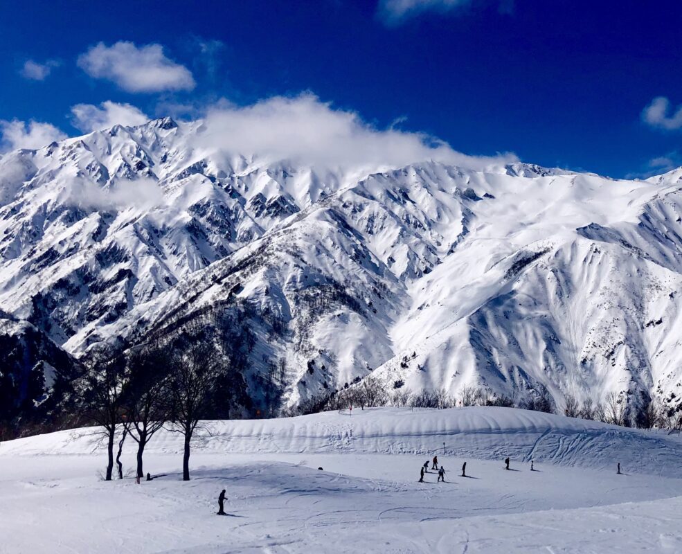 Hakuab Happo image of Japanese Alps with skiers in the foreground