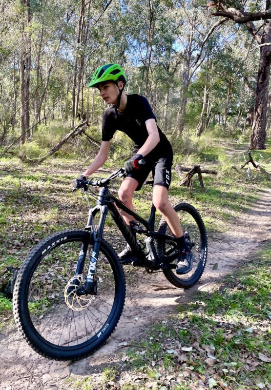 Mountian bike rider on black bike riding the Plenty Gorge mountain bike trails