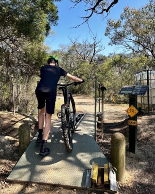 mountain bike rider washing wheels at Anglesea mtb park