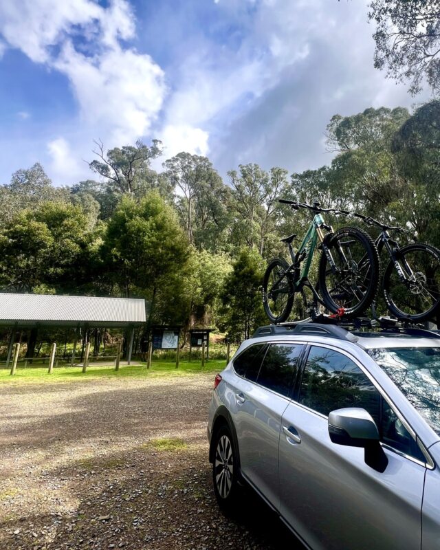 Car with bikes on roof, parked at the Buxton Mountain Bike Park trailhead.