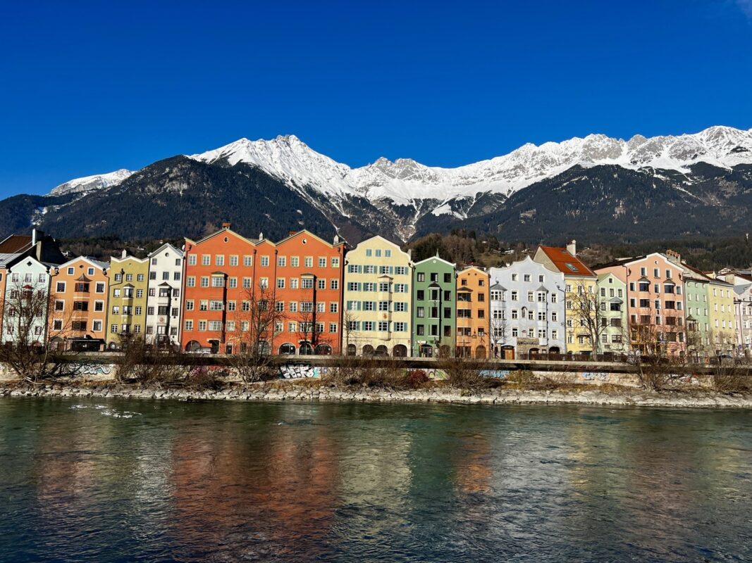 View of Innsbruck with mountains in the background and river in the foreground