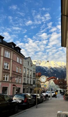 Street view of Innsbruck old town with mountains in the background
