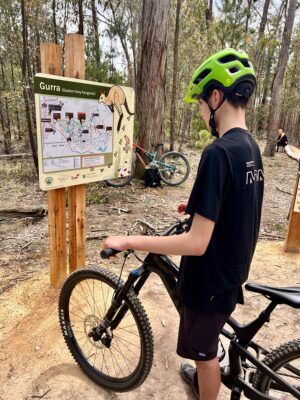 Mountain bike rider looking at the Creswick mountain bike trails map