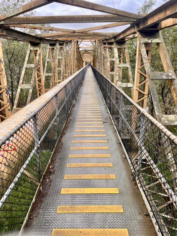 Pipe bridge near Fairfield boathouse looking down the bridge, along the Yarra mtb trails.