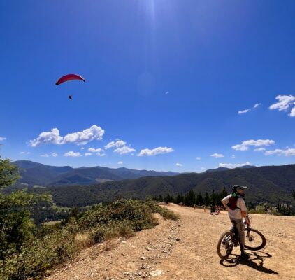 The Mystic trails shuttle drop off point with mtb rider and paraglider